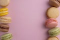 Macaroons colorful cookies. Macarons french sweet dessert, top view, pink background. Copy space Royalty Free Stock Photo