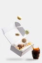 Macaroons Falling Down To Box. Flying Action Creative Food Photo