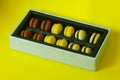 Macaroons gift box on yellow background Royalty Free Stock Photo
