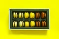 Macaroons gift box on yellow background Royalty Free Stock Photo