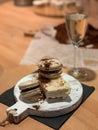 Macaroons with nut filling and a cake lie on a wooden board Royalty Free Stock Photo