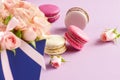 Macaroons in pastel colors with bouquet of pink roses flowers Royalty Free Stock Photo