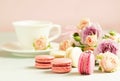 Macaroons in pastel colors with flowers on a pale pink background.Holiday background Royalty Free Stock Photo