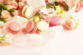 Macaroons in pastel colors with flowers on a pale pink background.Holiday background Royalty Free Stock Photo