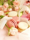 Macaroons in pastel colors with flowers on a pale pink background.Holiday background Royalty Free Stock Photo