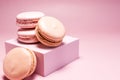The macaroons are pink and orange and the decor is pink d