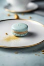 Macaroons in a white plate on a blue background. French dessert.