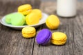 Macaroons on wood table with obe bottle of milk Royalty Free Stock Photo