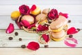 Macaruns with red roses and coffee Royalty Free Stock Photo