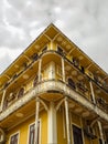 MACAU, CHINA - NOVEMBER 2018: Old yellow residential building in the city center with Portuguese and Macanese features