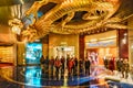 City of Dreams Casino interior in Macao. Metal sculpture of Golden Dragon chasing flaming pearl