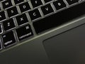 Macbook keyboard utilizing backlit keyboard illumination.
