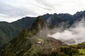 Macchu Picchu before sunrise covered in rising clouds Royalty Free Stock Photo