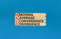 MACD symbol. Concept words MACD moving average convergence divergence on wooden stick on beautiful blue background. Business MACD Royalty Free Stock Photo