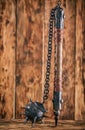 Mace with a stick and spikes on a wooden background. Royalty Free Stock Photo