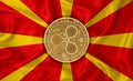 Macedonia flag, ripple gold coin on flag background. The concept of blockchain, bitcoin, currency decentralization in the country