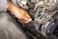 Machanic, worker hand-holding wrench repair car alternator in a garage. Repairing and maintenance automobile concept