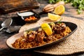 Machboos Hamour biryani rice with lime, raita and chilli sauce served in dish isolated on table top view of arabic breakfast