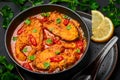 Macher Jhol in black bowl on dark slate table top. Indian cuisine Bengali Fish Curry. Asian food and meal. Close up Royalty Free Stock Photo