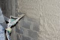 Machine application of plaster to the wall. Plasterer spraying plaster on wall. Professional, painting. Plastering walls in a new Royalty Free Stock Photo