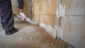 The process of applying plaster from a hose to the wall. Plasterer spraying plaster on wall. Professional, painting Royalty Free Stock Photo