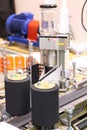 Machine for applying self-adhesive labels. The machine is designed for automatic labeling on a cylindrical container Royalty Free Stock Photo