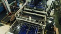 Machine with blue conveyor belt works at papermaking plant