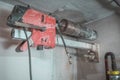 Machine for drilling holes in hthe concrete wall. Red professional drill for making holes in the walls. Back view with diamant Royalty Free Stock Photo