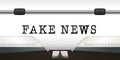 The word fake news is write on a white sheet of a typewriter. Royalty Free Stock Photo