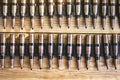 Machine gun ammo on a wooden table, bullet belt, bandoleer, chain of ammo on wooden background,cartridge 7.62 mm caliber, top view Royalty Free Stock Photo