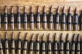 Machine gun ammo on a wooden table, bullet belt, bandoleer, chain of ammo on wooden background,cartridge 7.62 mm caliber, top view Royalty Free Stock Photo