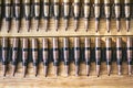 Machine gun ammo on a wooden table, bullet belt, bandoleer, chain of ammo on wooden background,cartridge 7.62 mm caliber, top view Royalty Free Stock Photo