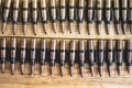 Machine gun ammo on a wooden table, bullet belt, bandoleer, chain of ammo on wooden background,cartridge 7.62 mm caliber, top view Royalty Free Stock Photo