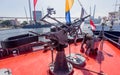 Machine gun on modern military battleship. View on Zolotoy bridge over Zolotoy Rog bay on background. Russia, Vladivostok Royalty Free Stock Photo