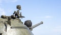 Machine gun on the turret of an armored personnel carrier. Heavy weapons of war, blue sky background. Army equipment for combat Royalty Free Stock Photo