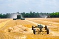 The machine for harvesting grain crops - combine harvester in action on rye field at sunny summer day. Agricultural machinery