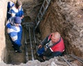 Machine for installing sewerage. The workers are discussing a technical problem