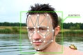 Facial Recognition System concept. The face of a young man with a frog on his shoulder. Biometric protection Royalty Free Stock Photo