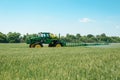 Machine moving through wheat field