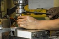 The machine operator change the tool at NC milling machine