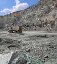 Machine pumps plastic explosives into holes. Mining in quarry.