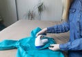 Machine for removing pellets. The girl uses a special device to remove lint from clothes. Restoration of old damaged clothes Royalty Free Stock Photo