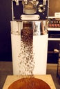 Machine for roasting coffee dispensing roasted beans into Royalty Free Stock Photo