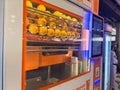A close-up shot of a modern, automated vending machine specifically designed to squeeze fresh orange juice. Royalty Free Stock Photo