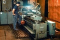 Machine shop - old lathe with wooden floor gangway Royalty Free Stock Photo