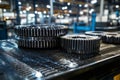 A machine shop setting features a workbench with precision-engineered metallic components and gears arranged on it Royalty Free Stock Photo