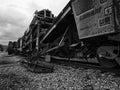 A machine to do railroad ballast maintenance with stormy skys