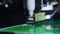 Machine working on surface of PCB printed circuit board putting on soldering paste. Soldering paste dispenser. Modern