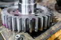 The machined toothed gear on the cnc machine lies on the board in the workshop