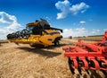 Machinery combine harvester on stubble wheat field